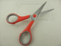 Scissors with red plastic handle